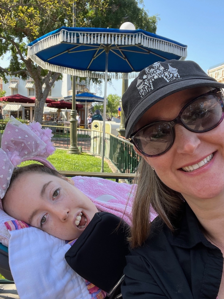 Jennifer Swann takes a selfie with Kennedy at Disney World on a sunny day.