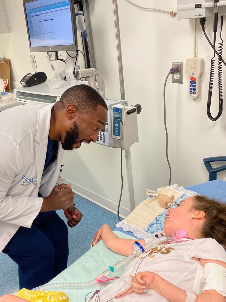 Kennedy Swann at the hospital, smiling as a kind and energetic doctor entertains her.